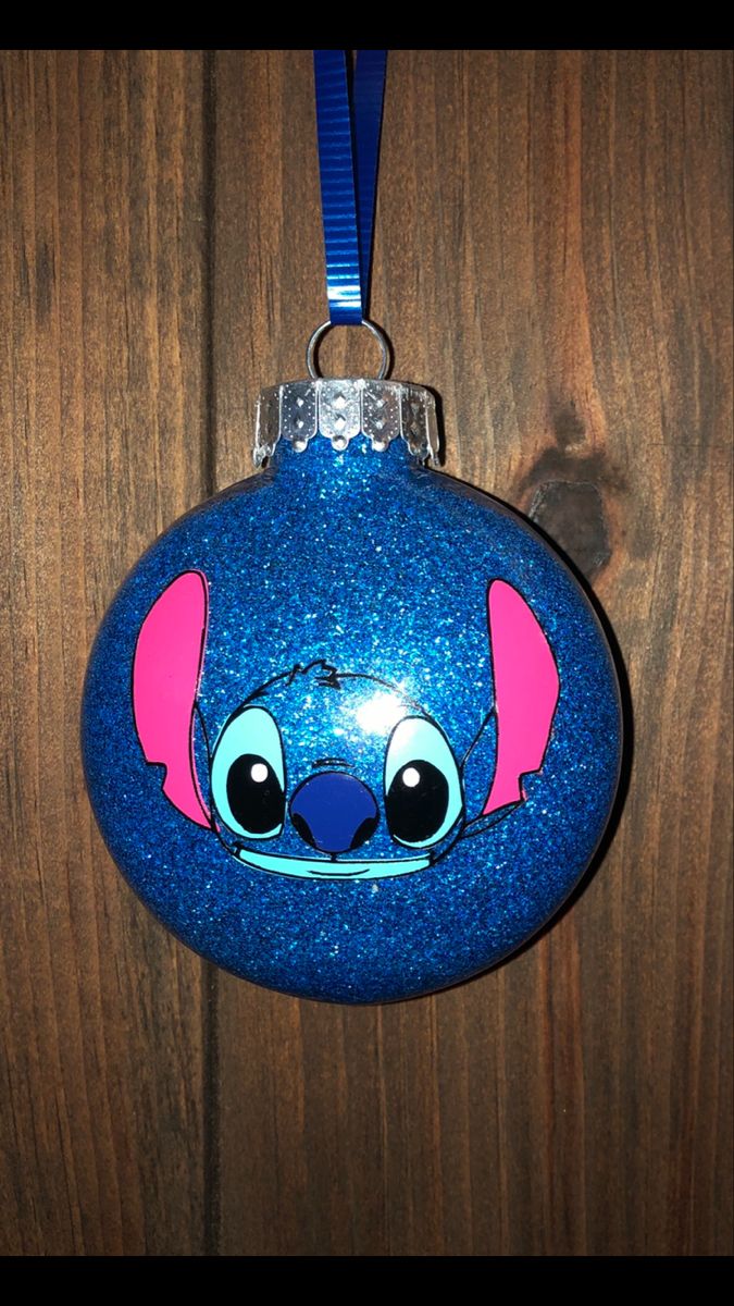 a blue ornament with an image of stitchy ears on it's face