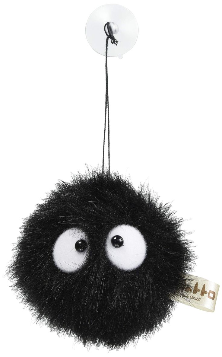 a black and white stuffed animal hanging from a cord with eyes on it's head