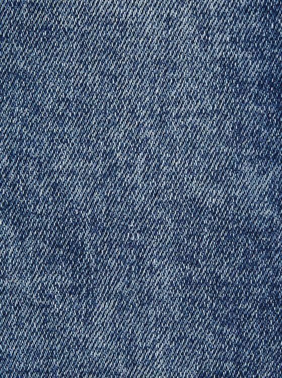 the back side of a pair of blue jeans, with an over - dyed pattern