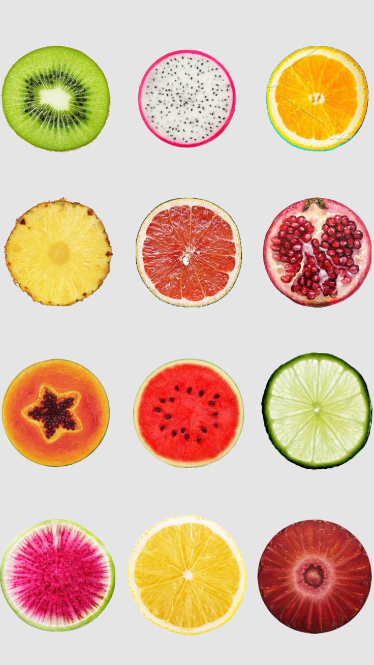 different types of fruit cut in half on a white background, including kiwis, oranges and watermelon