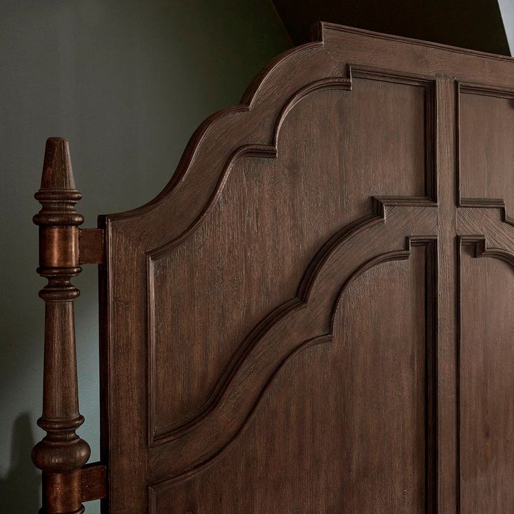 a large wooden bed frame in a bedroom