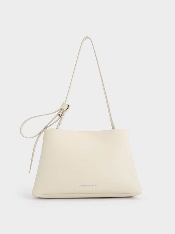 This product is made with at least 20% sustainable materials by weight. CHARLES & KEITH uses recycled, degradable, organic, and water-based materials in our eco-conscious collection.If you are looking for a bag that can add a distinctive touch to any look, this Odella bucket bag tick all the boxes. It features a striking trapeze silhouette that is semi-slouchy in construction -- the minimalist design lets the unconventional shape be the star of the show. It also comes with a magnetic closure tha Modern Everyday Recyclable Bags, Modern Recyclable Bags For Everyday Use, Modern Recyclable Shoulder Bag For Shopping, Modern Recyclable Tote Bag, Recyclable Double Handle Shoulder Bag For Daily Use, Recyclable Double Handle Shoulder Bag For Shopping, Eco-friendly Recyclable Shoulder Bag With Double Handle, Versatile Recyclable Shoulder Bag, Versatile Recyclable Shoulder Bag For Daily Use