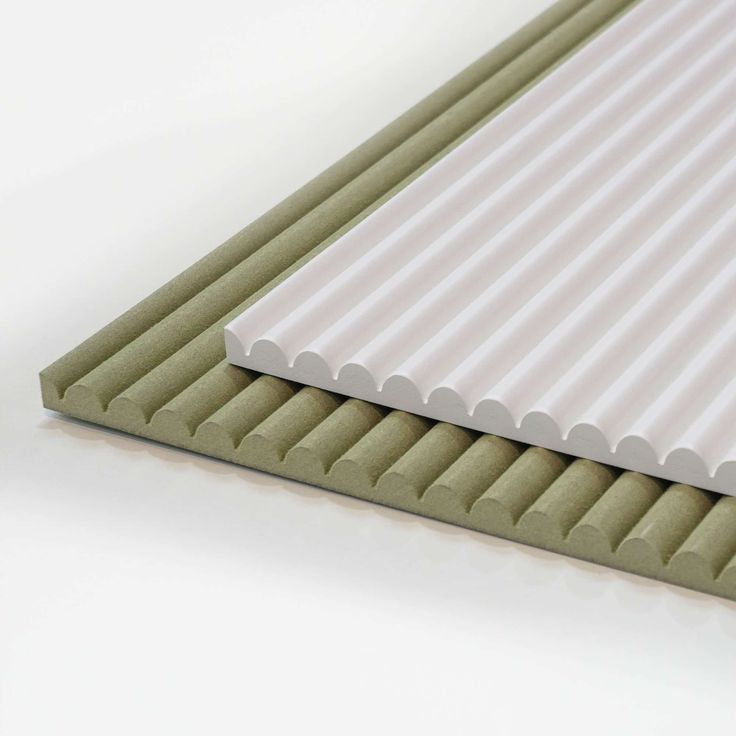 an image of a white and green corrugated roofing sheet on a white table top