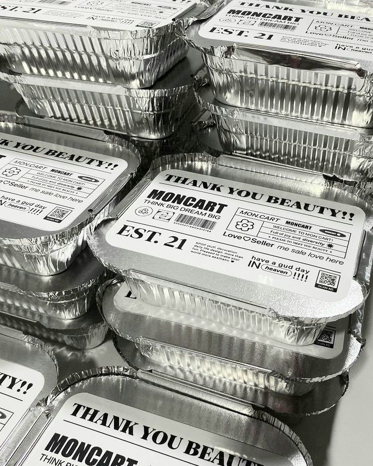 many aluminum foil containers are stacked on top of each other with the words thank you beauty printed on them