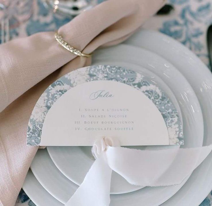 a table setting with place settings and napkins