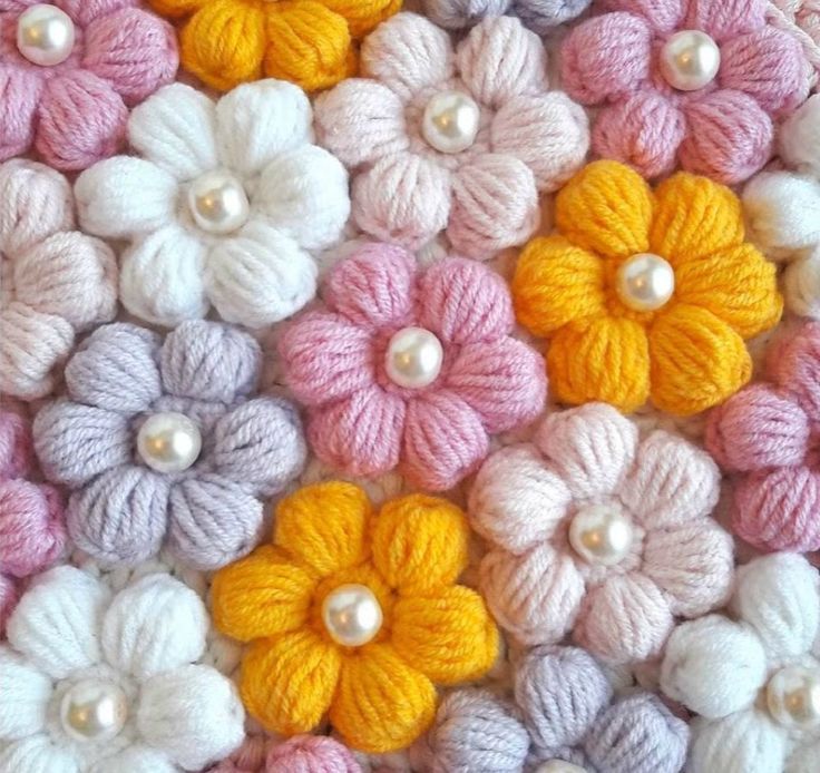 multicolored crochet flowers with pearls on the center and in the middle