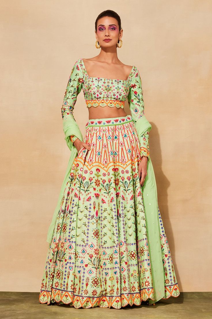 Mint green lehenga with geometric prints, cutdana, mirror embroidery and comes with separate cancan. Paired with embroidered blouse and dupatta.
Components: 4
Pattern: Printed, Embroidered
Type Of Work: Geometric
Neckline: Square
Sleeve Type: Full
Fabric: Raw silk, Lining: Shantoon, mul
Color: Green
Other Details: 
Scallope detailing
Note: The mint green lehenga set shown in the image is only being sold
Occasion: Wedding - Aza Fashions Mint Green Lehenga, Mirror Embroidery, Green Lehenga, Geometric Prints, Embroidered Lehenga, Embroidered Blouse, Raw Silk, Set For Women, Indian Outfits