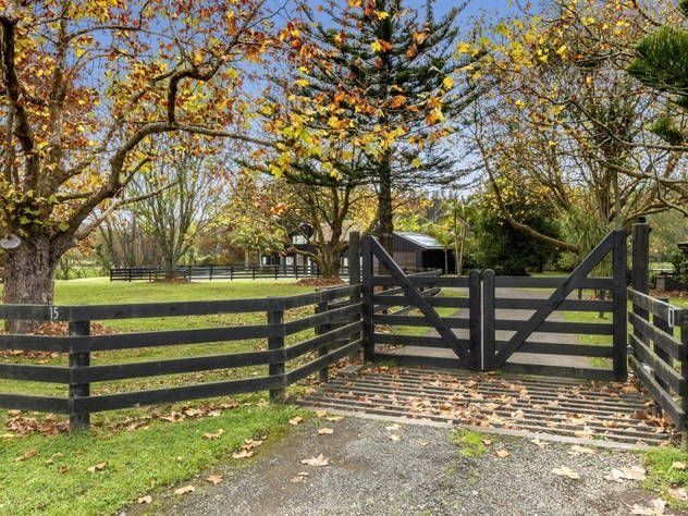 a gated in area with trees and grass