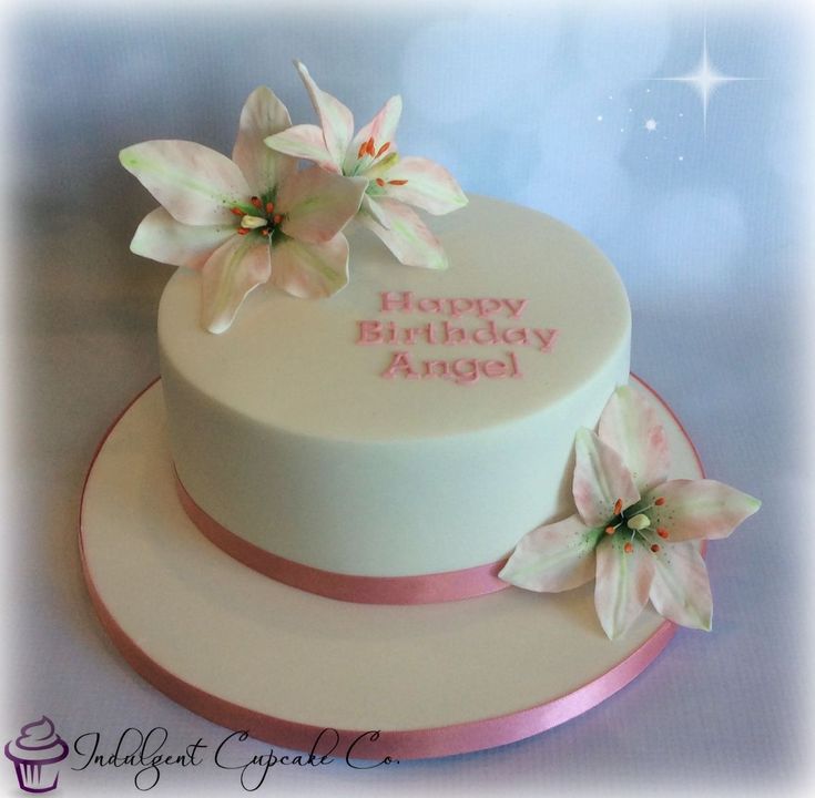 a birthday cake decorated with flowers and the words happy birthday angel