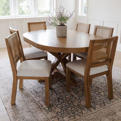 a wooden table with four chairs around it