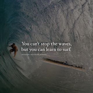 a man riding a wave on top of a surfboard in the middle of it