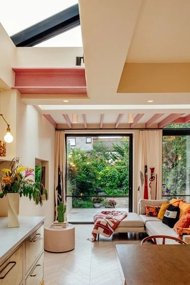 a living room filled with furniture next to a kitchen and an open door leading to a patio