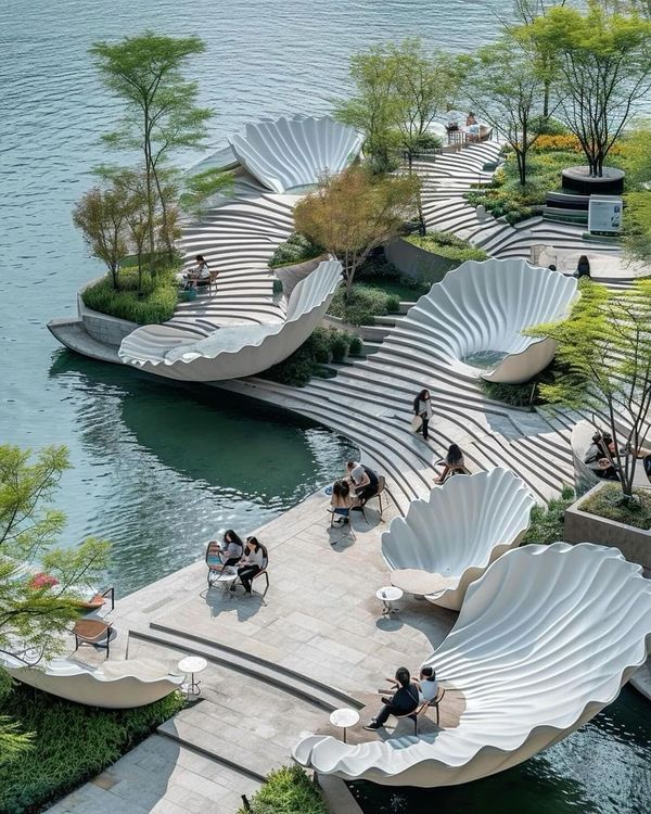 people are sitting on benches near the water