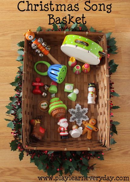 a christmas song basket filled with toys on top of a wooden floor