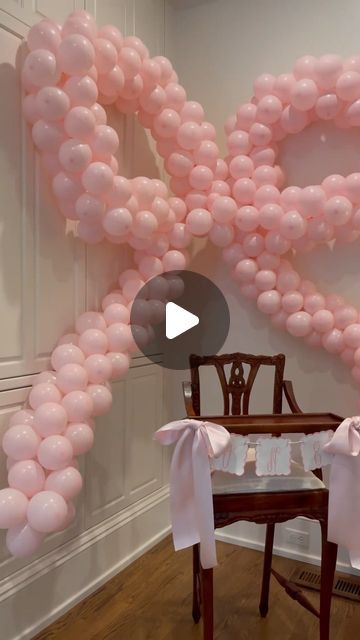 pink balloons are arranged in the shape of a heart