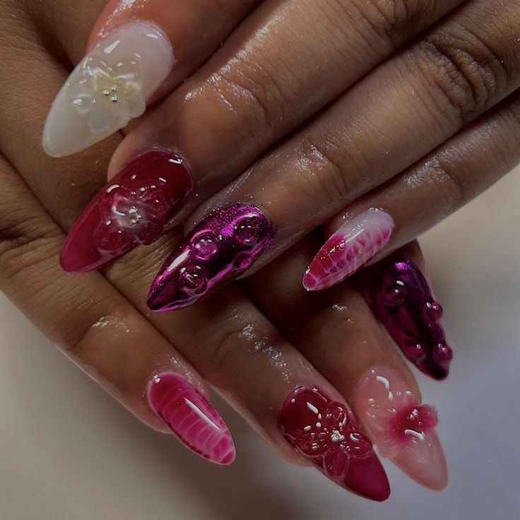 a woman's hand with pink and white nail polishes on her nails,