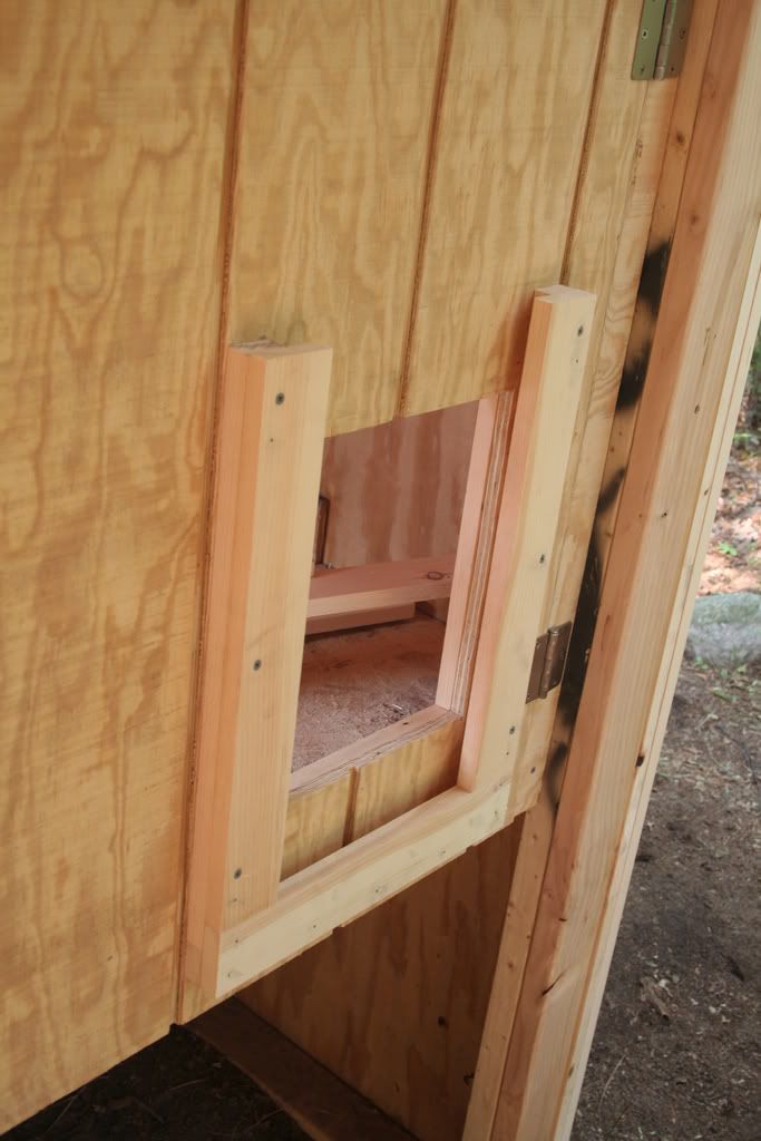 the inside of a wooden shed with its door open