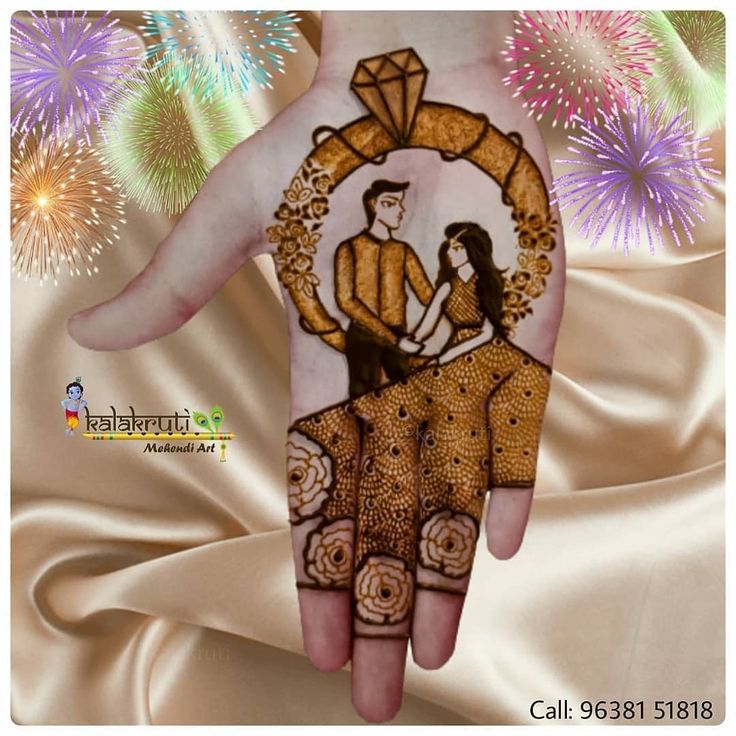 a hand painted with an image of a man and woman on it, surrounded by fireworks