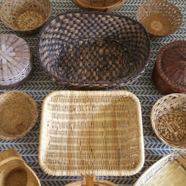 wicker baskets are laid out on the floor with different patterns and sizes to choose from