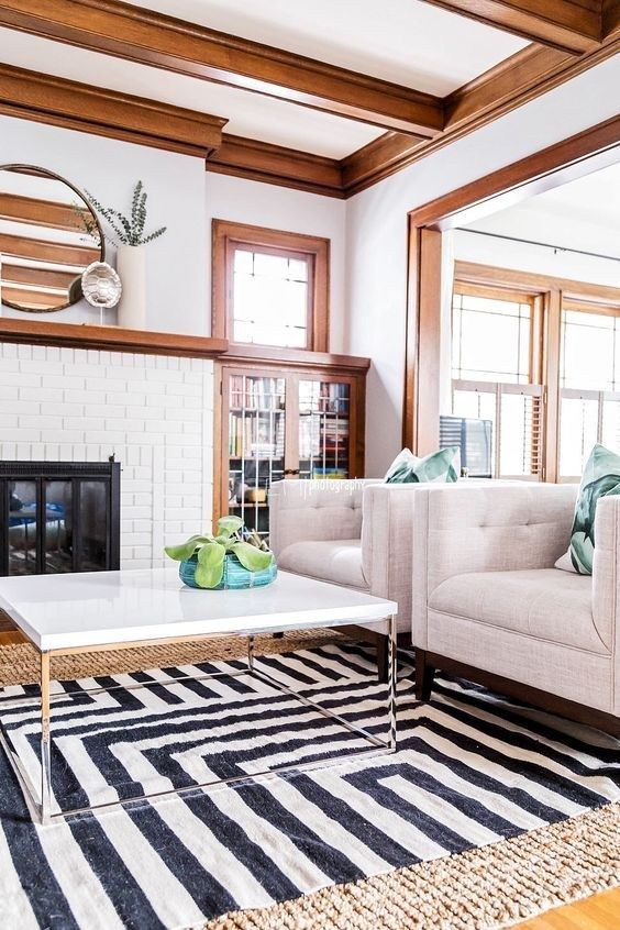 a living room with two couches and a coffee table in front of a fireplace