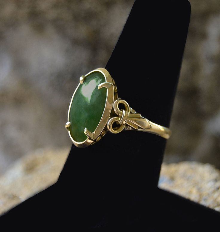 "Estate Vintage JADEITE Oval Cabochon 14k Gold YLK size 6 1/4 size 6 1/4 This ring contains (1) Natural Oval Old Mine Deep Green Cabochon Jadeite Center Stone. Measuring: approximately 14.35 X 9.35 X 2.60mm The Ring is Yellow Gold ... Stamped 14K Y.L.K. The Jadeite is Set with Four (4) Prongs in the Center. The Shank is : Width: approximately 2.22mm Jadeite is among the most valuable of all gemstones. Jade is considered the \"Stone of Heaven\" and is thought to provide a bridge between this worl Green Opal Oval Ring In 14k Gold, Victorian Oval Emerald Ring In Yellow Gold, Victorian Oval Yellow Gold Emerald Ring, Classic Gold Emerald Cabochon Ring, 14k Yellow Gold Emerald Ring Oval Cabochon, Antique Gold Emerald Ring With Oval Cabochon, Antique Emerald Ring In Gold With Oval Cabochon, Classic 14k Stamped Oval Cabochon Emerald Ring, Heirloom Gold Emerald Ring With Oval Cabochon