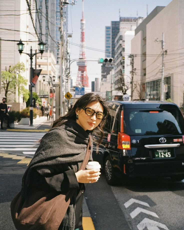 a woman standing on the side of a road