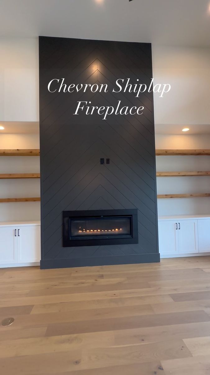 the chevron shiplap fireplace is shown in an empty room