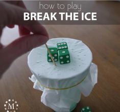 a cake with dices on it and the words how to play break the ice