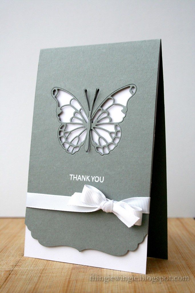 a card with a butterfly on it and the words thank you written in white ink