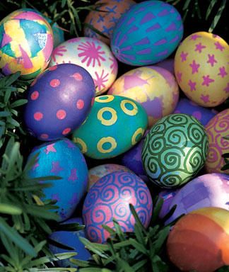 an arrangement of painted easter eggs in the grass