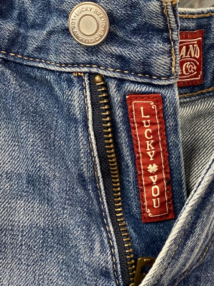 a close up view of the label on a pair of blue jeans with zippers