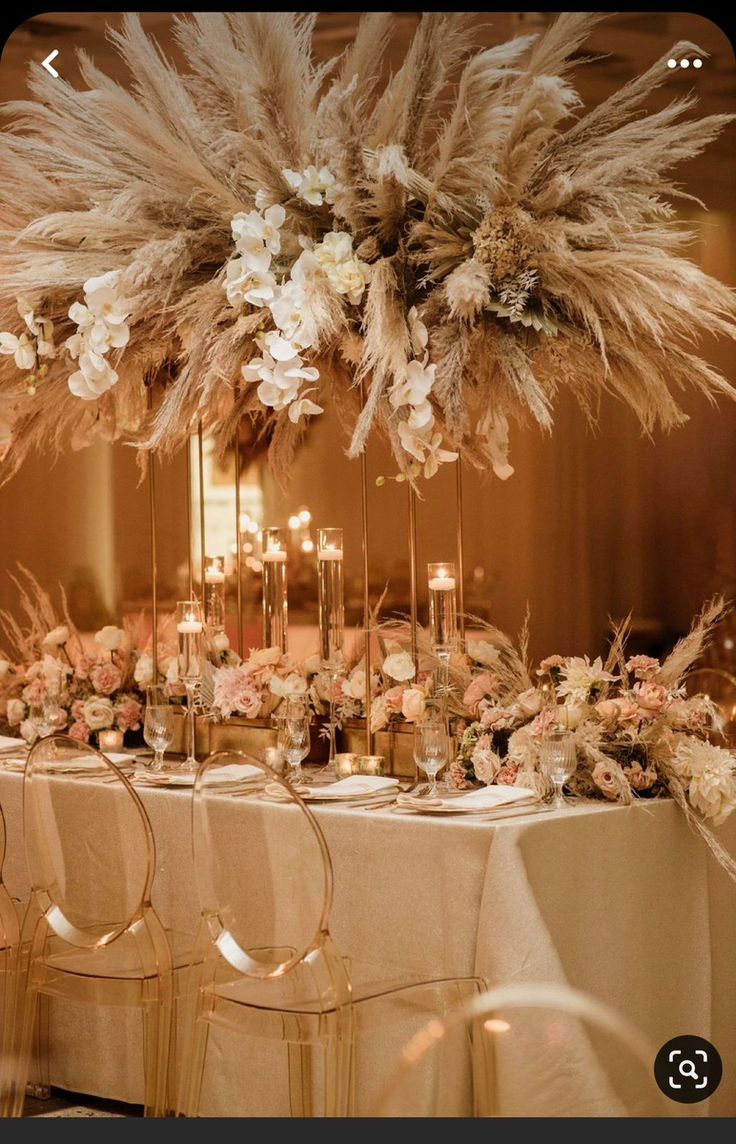 the table is set with tall centerpieces and flowers