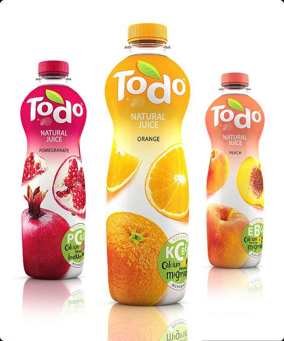 three bottles of juice with oranges and pomegranate