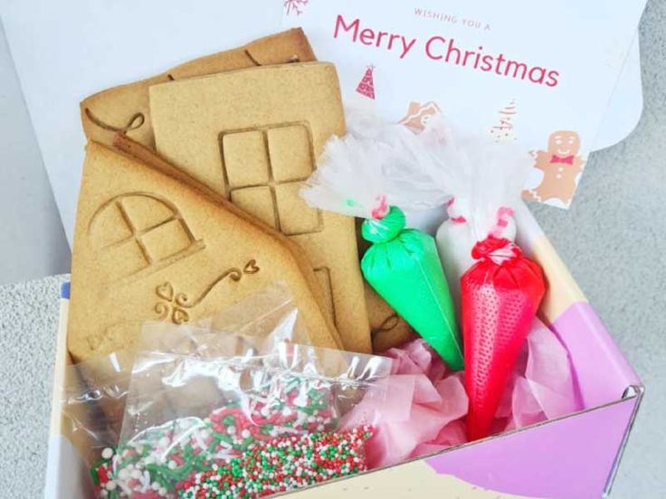 a box filled with lots of different types of cookies and other food items on top of a table