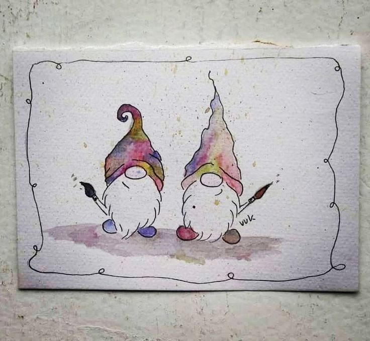 two gnomes standing next to each other in front of a white wall with an ornate frame