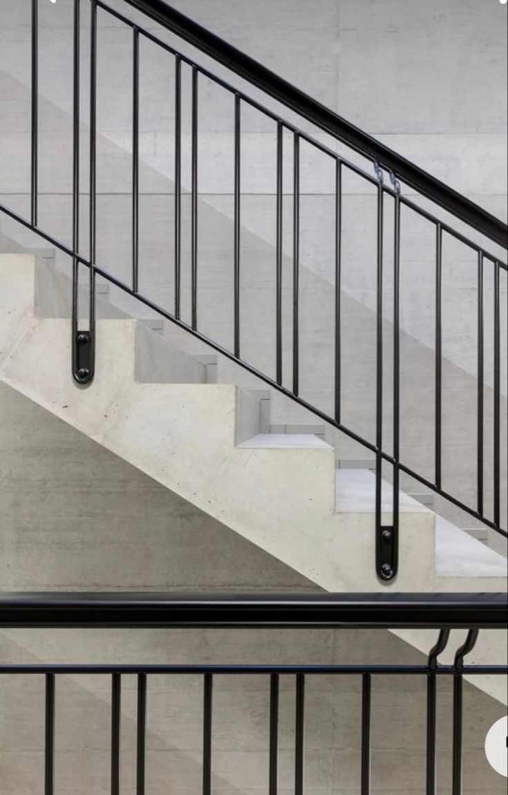 an image of a stair case with railings and handrails on concrete stairs