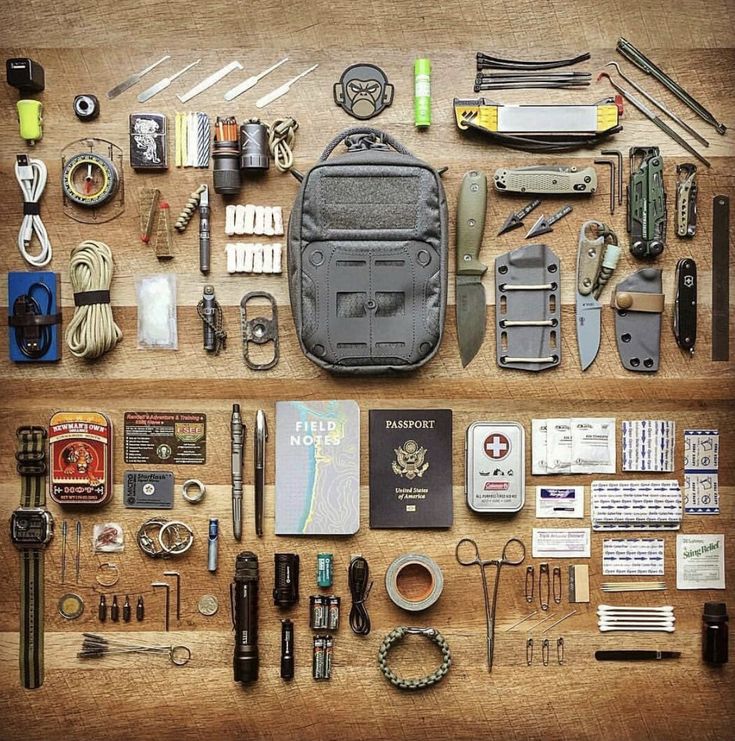 an assortment of items are laid out on a table together to be used as a survival kit