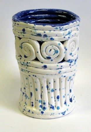 a blue and white ceramic vase sitting on top of a table