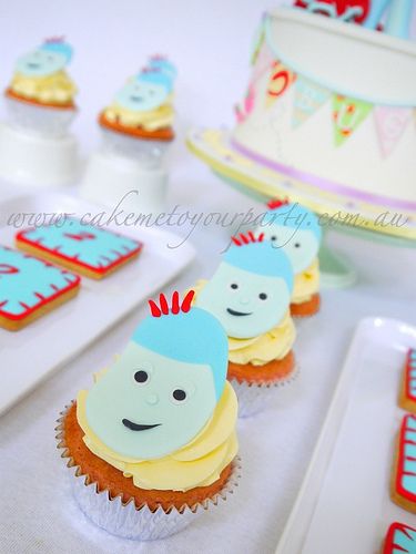 some cupcakes are sitting on a table with other desserts and cake items