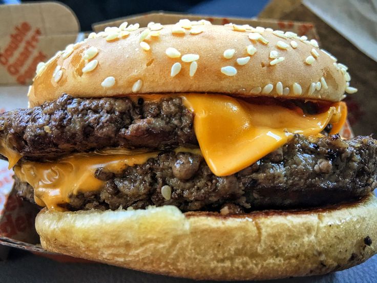 a hamburger with cheese and meat on it