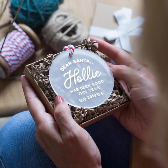 a person holding a small box with some yarn in it