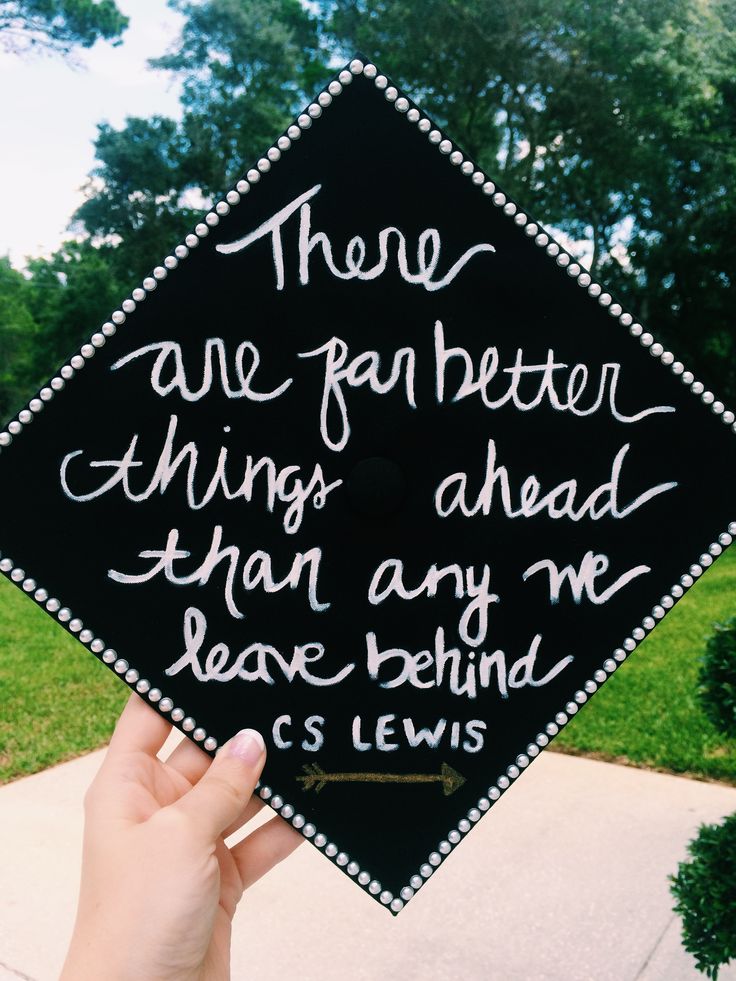 someone is holding up a graduation cap with writing on it