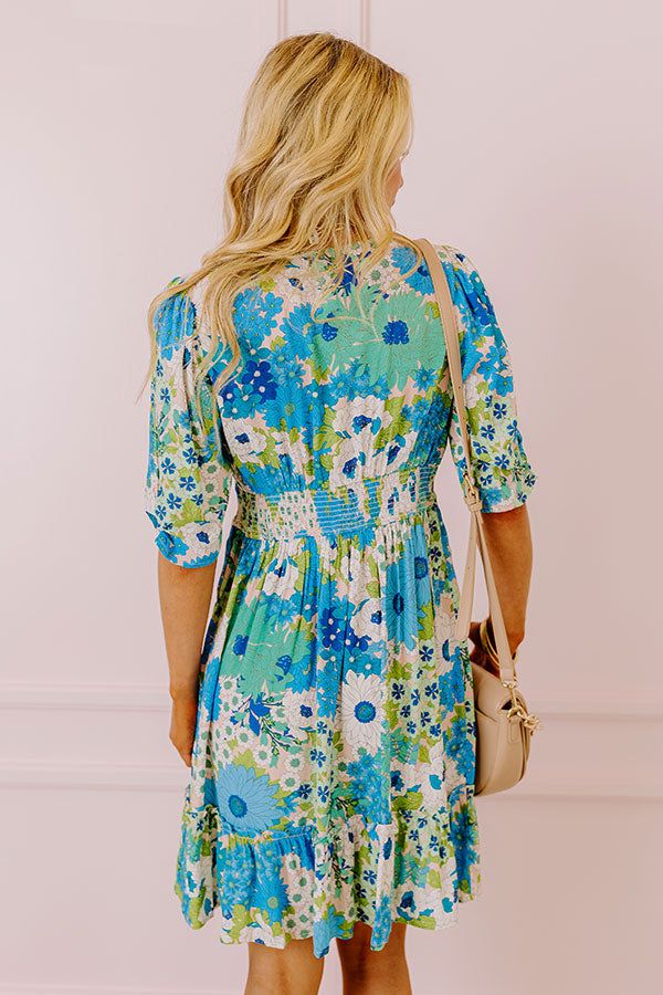 You will be the buzz of the town when you arrive in this pretty blue dress featuring lightweight breezy material patterned with a teal, green, and white floral print, a v-cut neckline with a front tie detail, loose half sleeves, and a relaxed skirt silhouette that falls into a straight mid-thigh length hemline! on products Measurements S : Bust 34", Hip 38", Length 36", Sleeve Length 12.5", Waist 28-30". M : Bust 36", Hip 40", Length 36", Sleeve Length 13", Waist 30-32". L : Bust 38", Hip 42", L Turquoise V-neck Mini Dress For Vacation, Blue Ditsy Floral Print Dress For The Beach, Blue Ditsy Floral Print Beach Dress, Blue Floral Sundress For Garden Party, Light Blue Summer Floral Dress For Vacation, Blue Floral Print Sundress, Blue Floral Dress With Ditsy Floral Print, Blue Ditsy Floral Print Knee-length Dress, Blue Knee-length Ditsy Floral Dress