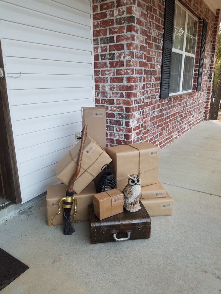 an owl sitting on top of boxes in front of a brick building with a door