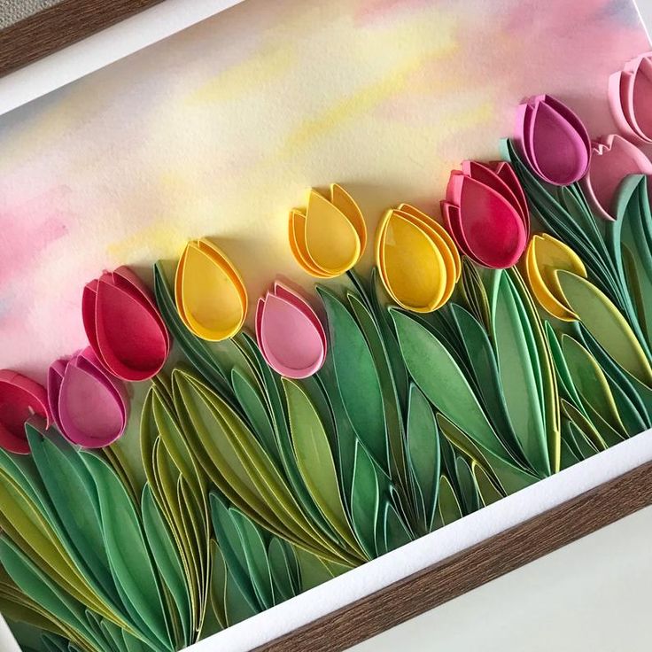 a painting with paper flowers on it