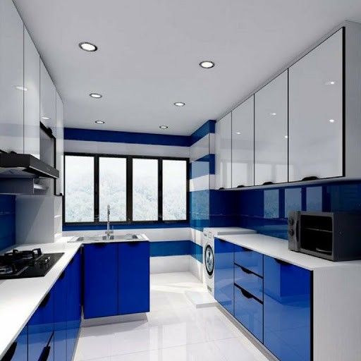 a blue and white kitchen with lots of counter space on one side, cabinets on the other