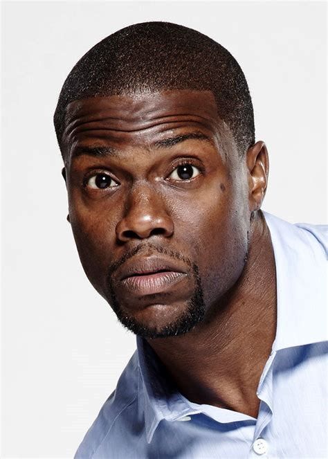 a close up of a person wearing a blue shirt and looking at the camera with a serious look on his face