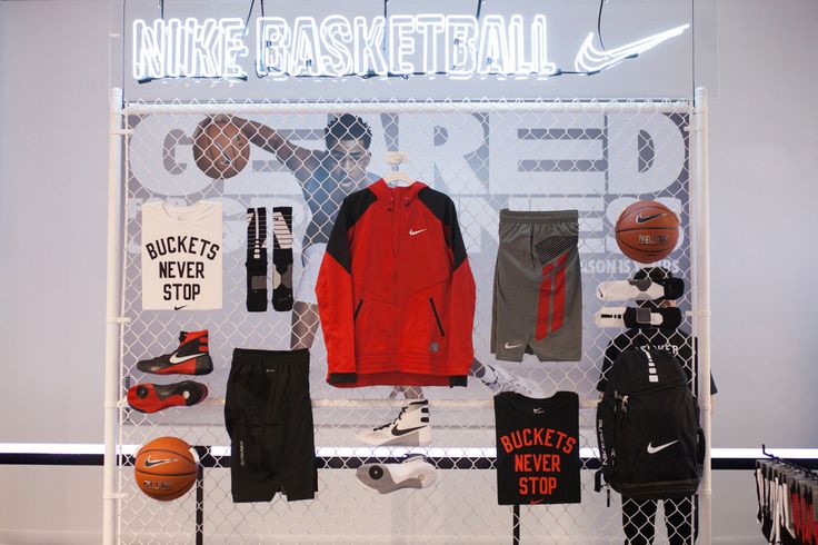 a display case filled with sports items and basketball gear on top of a white wall