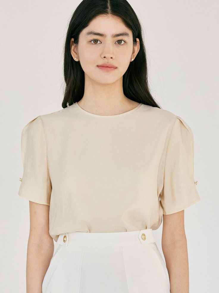 This product is an elegant half jewel blouse designed to add a touch of sophistication to any outfit. It features short sleeves with delicate jewel details and a classic round neckline. The blouse is crafted from a high-quality fabric that ensures comfort and a flattering fit. - This half jewel blouse has jewel embellishments on the sleeves, adding a subtle sparkle.- The round neckline provides a timeless and versatile look.- The short sleeves are designed for a comfortable and stylish fit.- The high-quality fabric ensures durability and a flattering silhouette. Elegant Cream Crew Neck Top, Fitted Crew Neck Elegant Blouse, Elegant Crew Neck Blouse For Formal Occasions, Elegant Beige Puff Sleeve Top, Elegant Spring Workwear T-shirt, Formal Padded Short Sleeve Blouse, Formal Short Sleeve Padded Blouse, Elegant Beige Crew Neck Blouse, Elegant Puff Sleeve Tops