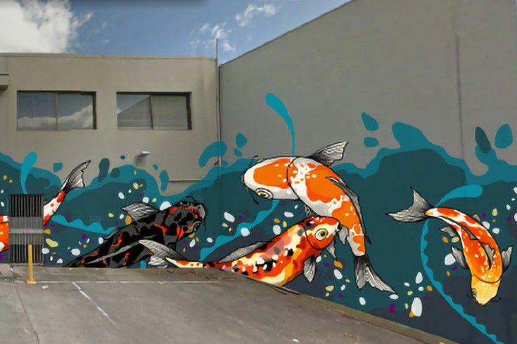 there is a mural on the side of a building with koi fish in it